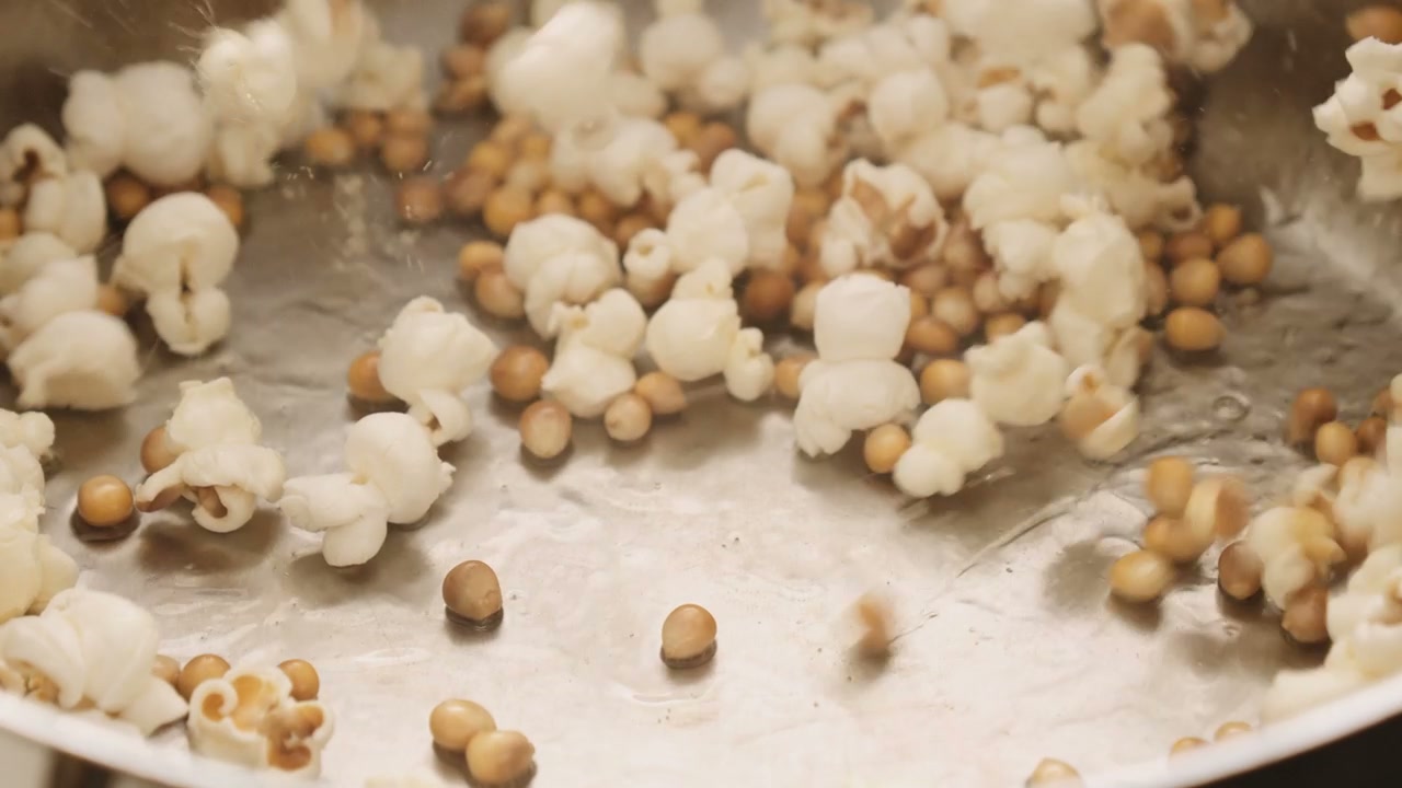 Popcorn Popping and Scattering in a Kitchen • Stock Video on Uppbeat