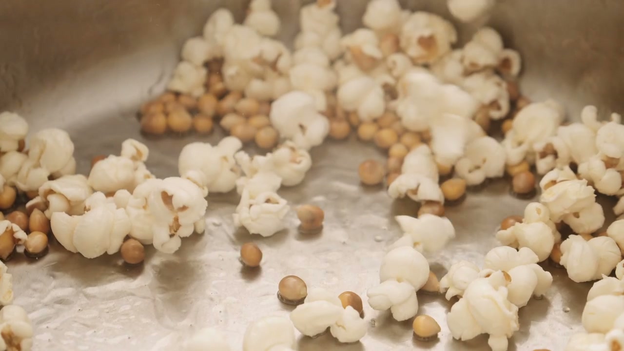 Popcorn Popping and Scattering in a Kitchen • Stock Video on Uppbeat