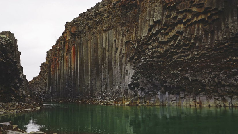 River Flowing Through Basalt Canyon, Iceland • Stock Video on Uppbeat