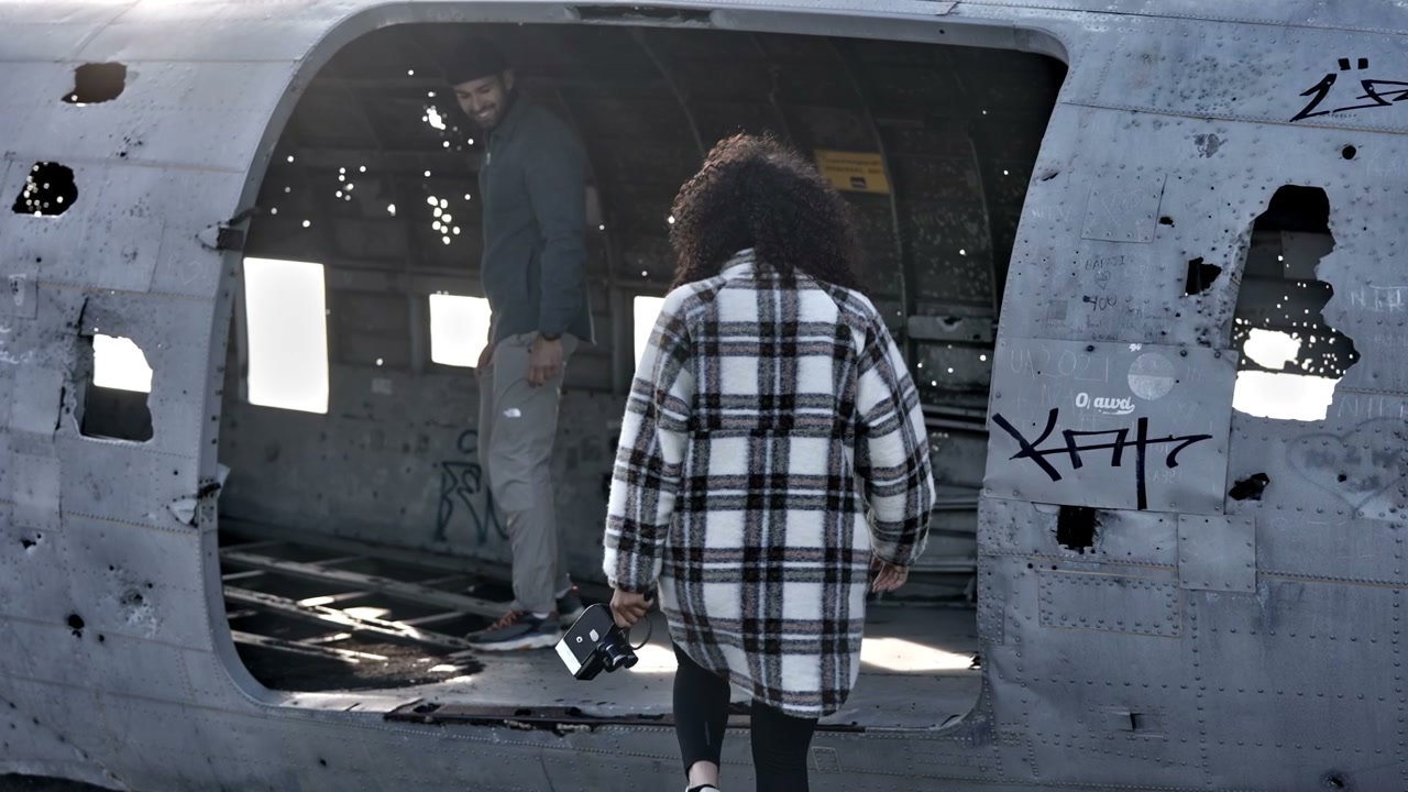 Couple Exploring Solheimasandur Plane Wreckage