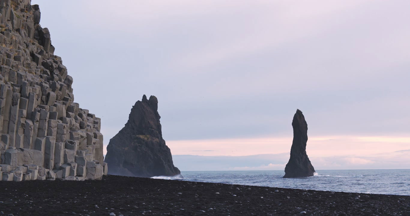 Aerial Black Sand Beach and Sea Stacks, Iceland • Stock Video on Uppbeat