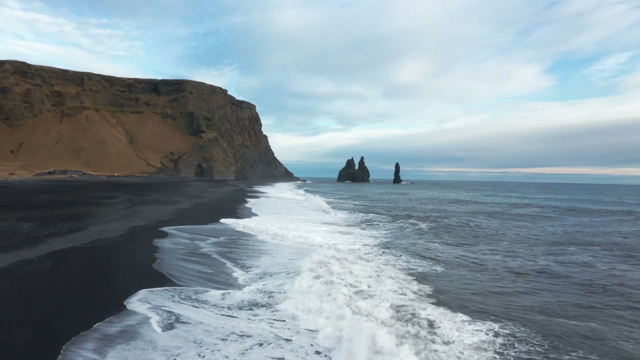 Icelandic Black Sand Beach with Sea Stack • Stock Video on Uppbeat