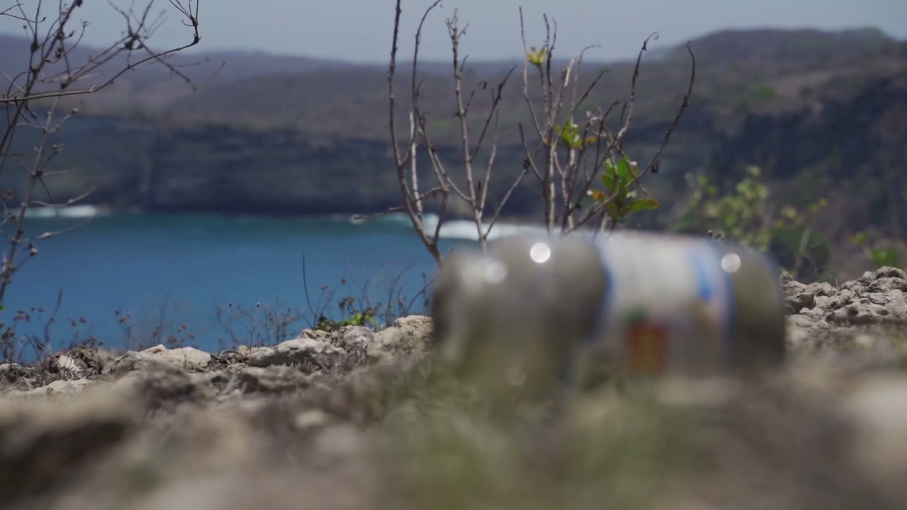 Discarded Jar on Coastal Cliff Overlooking Ocean