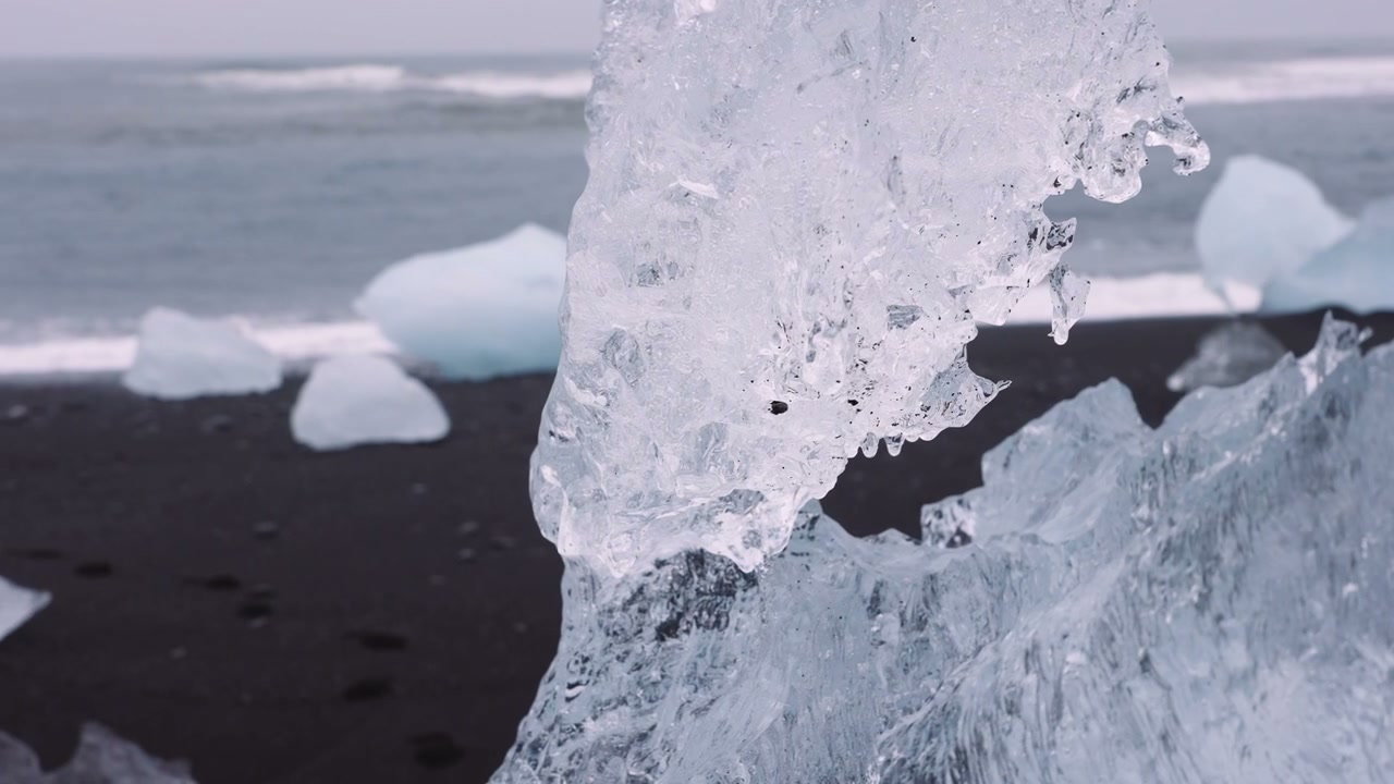 Ice Chunk on Black Sand Beach in Iceland • Stock Video on Uppbeat