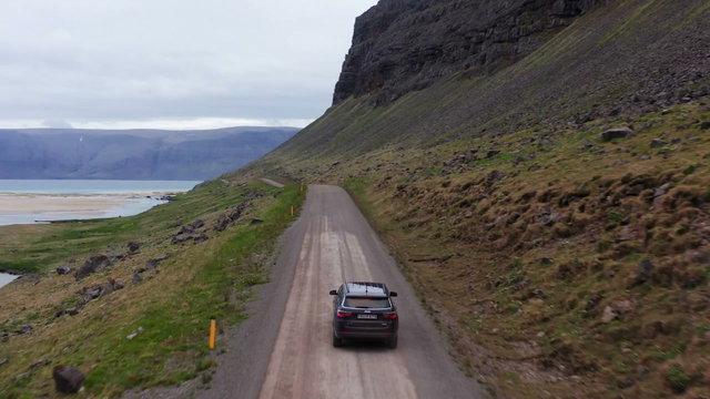 Car Driving on Remote Road by Fjord • Stock Video on Uppbeat