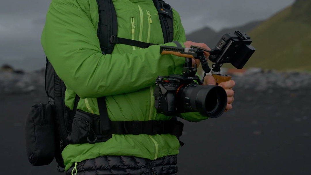 Filmmaker Adjusting Camera Rig Outdoors • Stock Video on Uppbeat