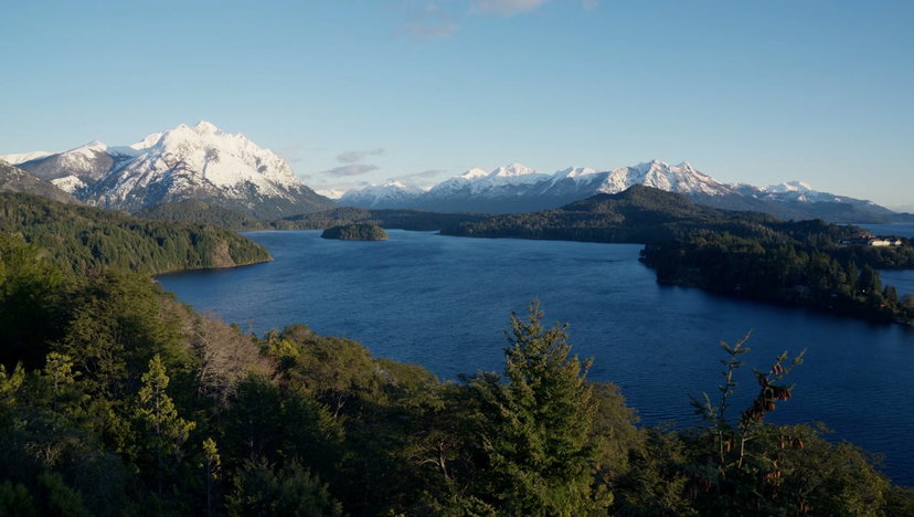 Man Raises Arms by Patagonian Lake at Sunrise • Stock Video on Uppbeat