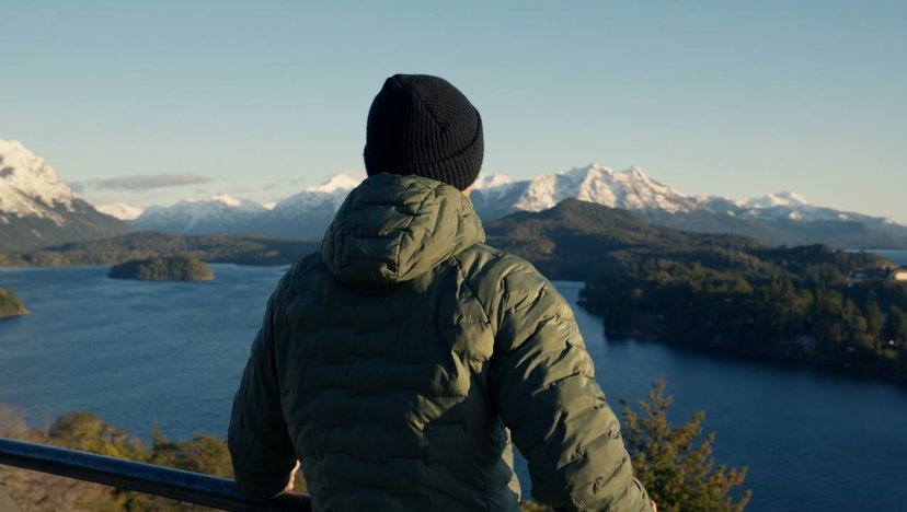 Man Raises Arms by Patagonian Lake at Sunrise • Stock Video on Uppbeat
