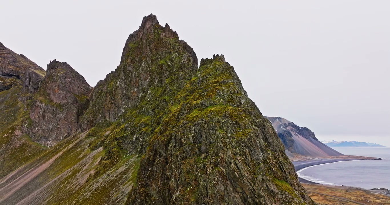 Aerial Pull Out Revealing Rugged Mountain Coast