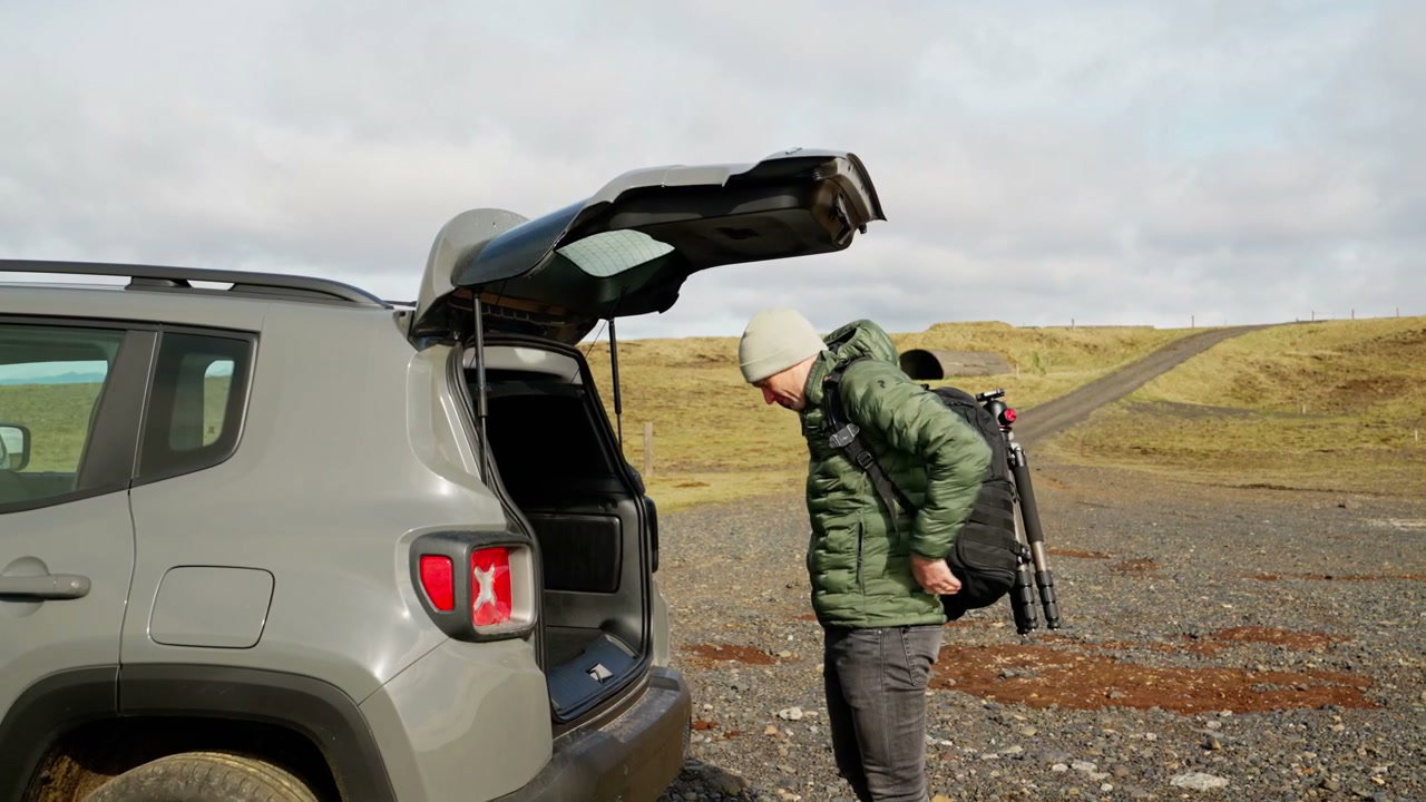 Man Preparing for Hike by Car