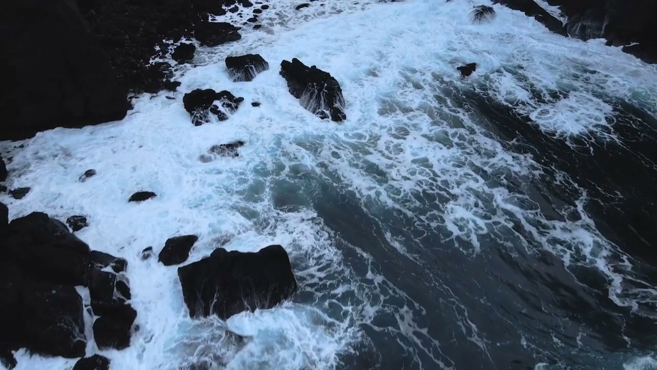 Aerial Waves Crashing Against Volcanic Rocks