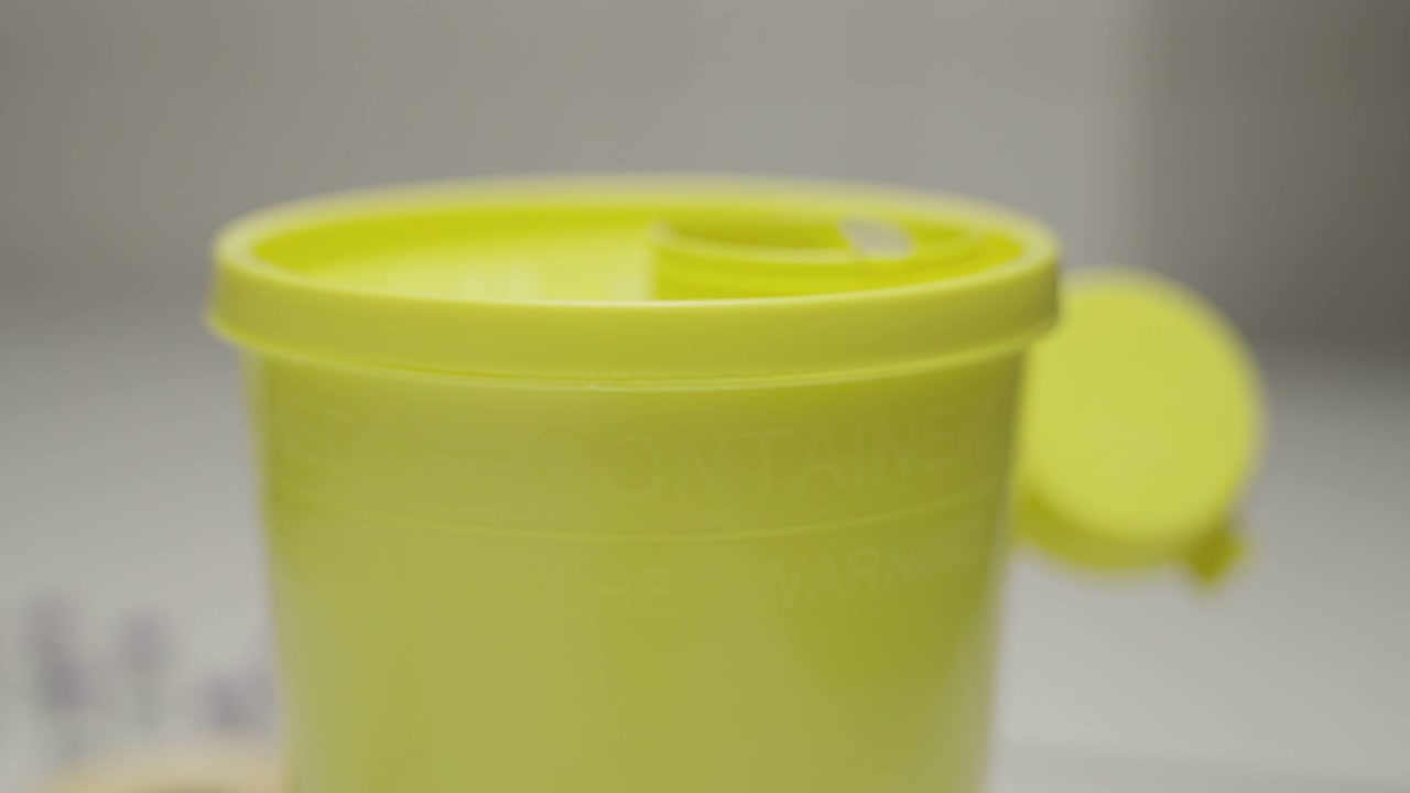 Disposing Used Syringe in Sharps Container