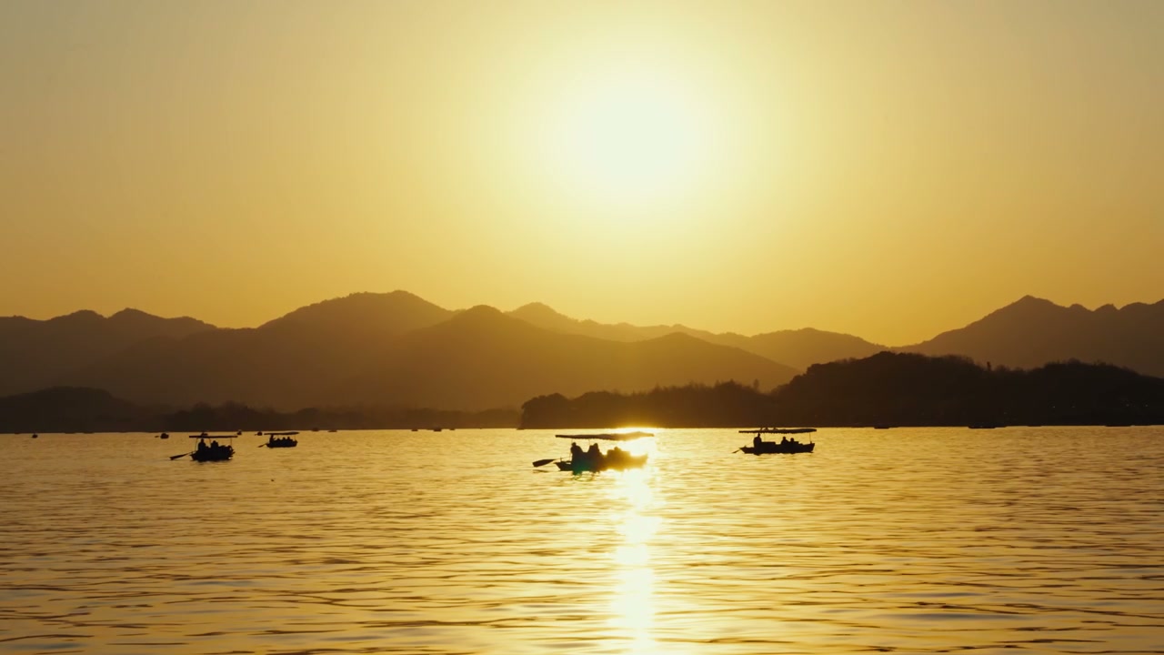People Boating on Lake at Golden Sunset