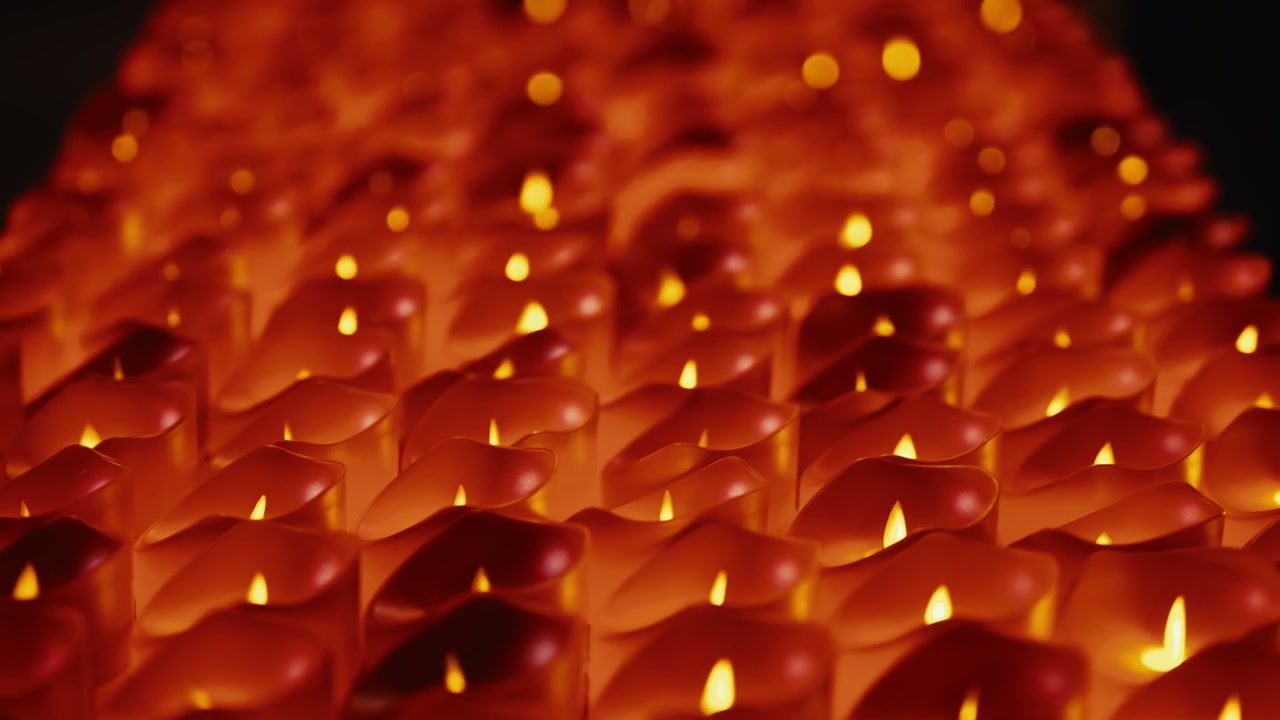 Many Flickering Candles Glowing in the Dark