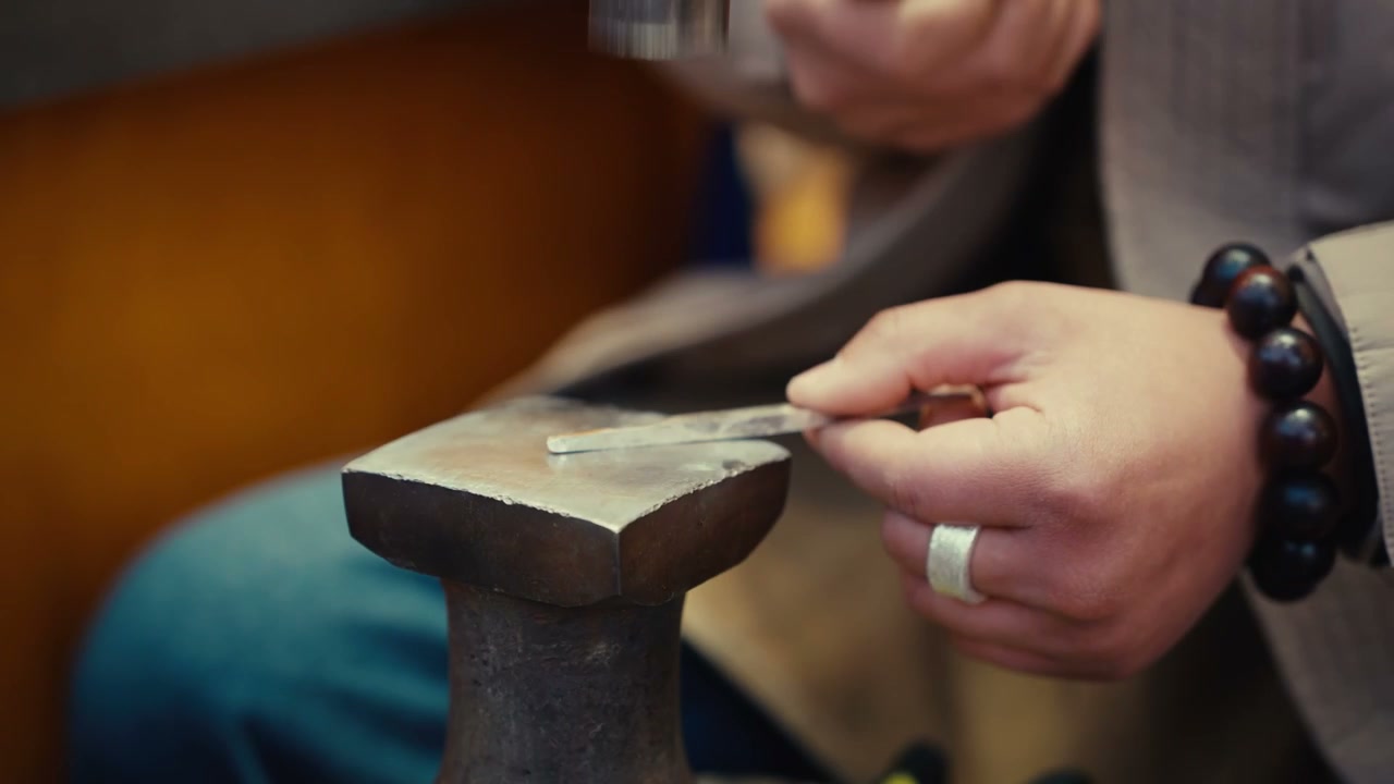 Craftsman Hammering Metal on Anvil
