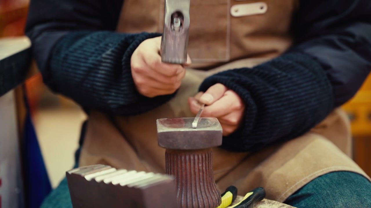 Artisan Shaping Metal with Hammer