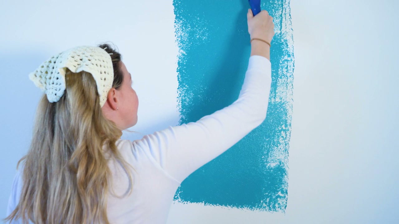 Person Painting a White Wall Blue