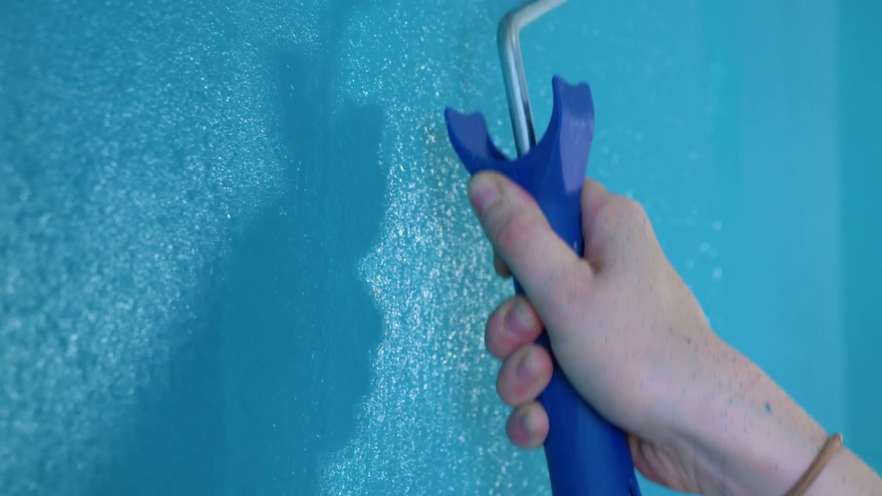 Painting Wall With Blue Roller