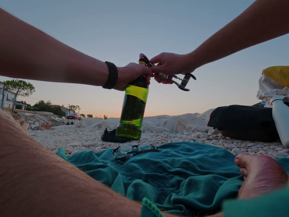 POV Bottle Opening on Beach at Dusk