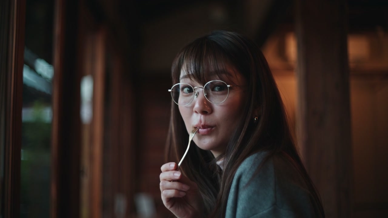 Contemplative Woman Holding Fork in Cafe