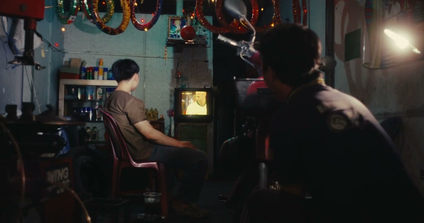 Men Watching Football in Mechanic Shop