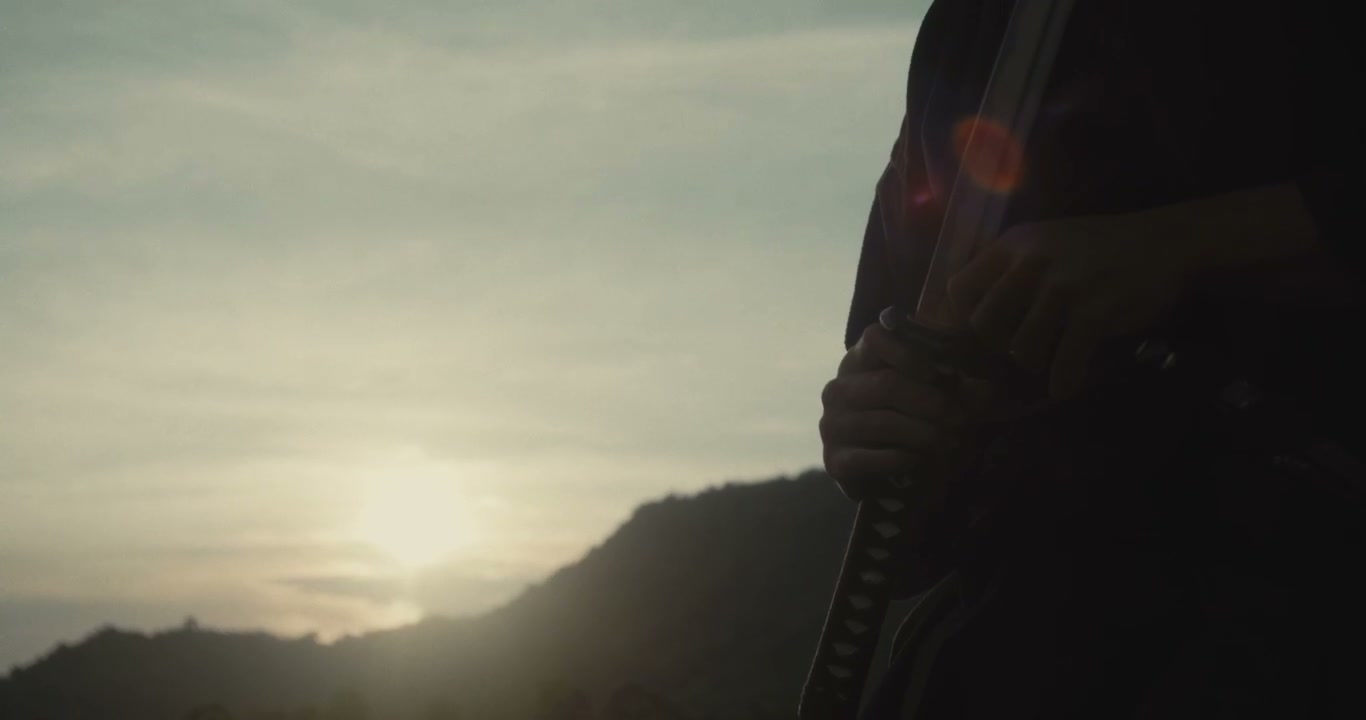 Samurai Sheathing Katana at Sunset