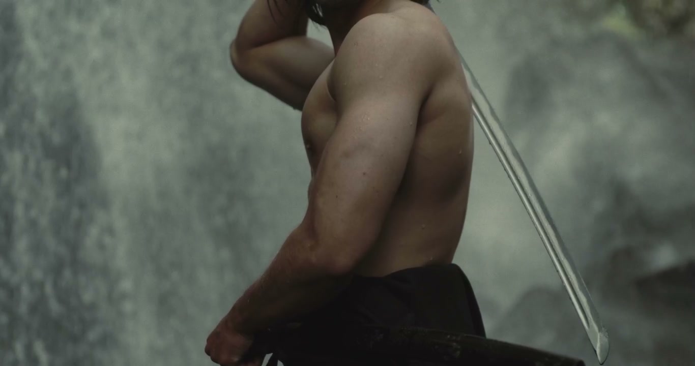 Samurai Warrior Posing with Katana by Waterfall
