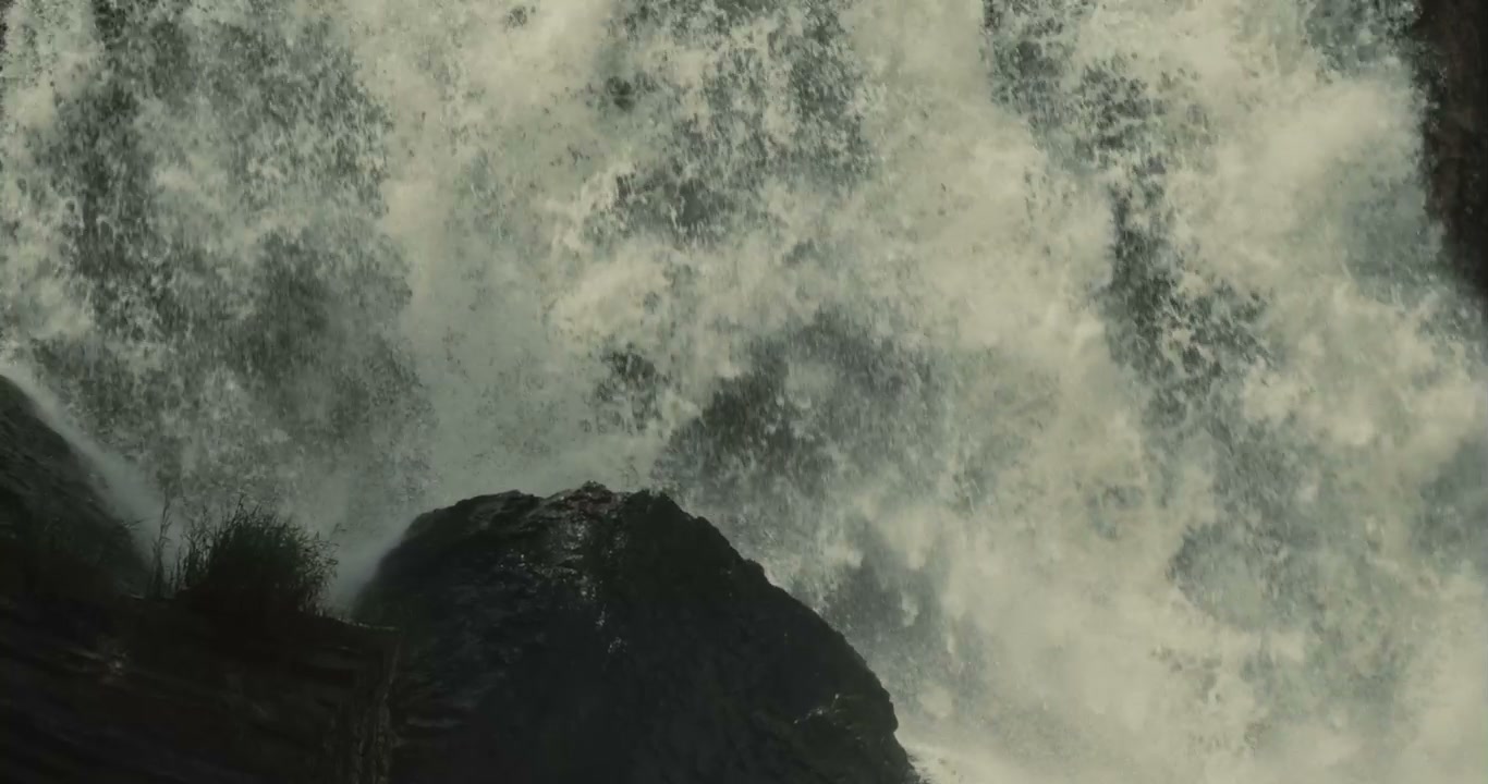 Powerful Waterfall Cascading Over Rocks
