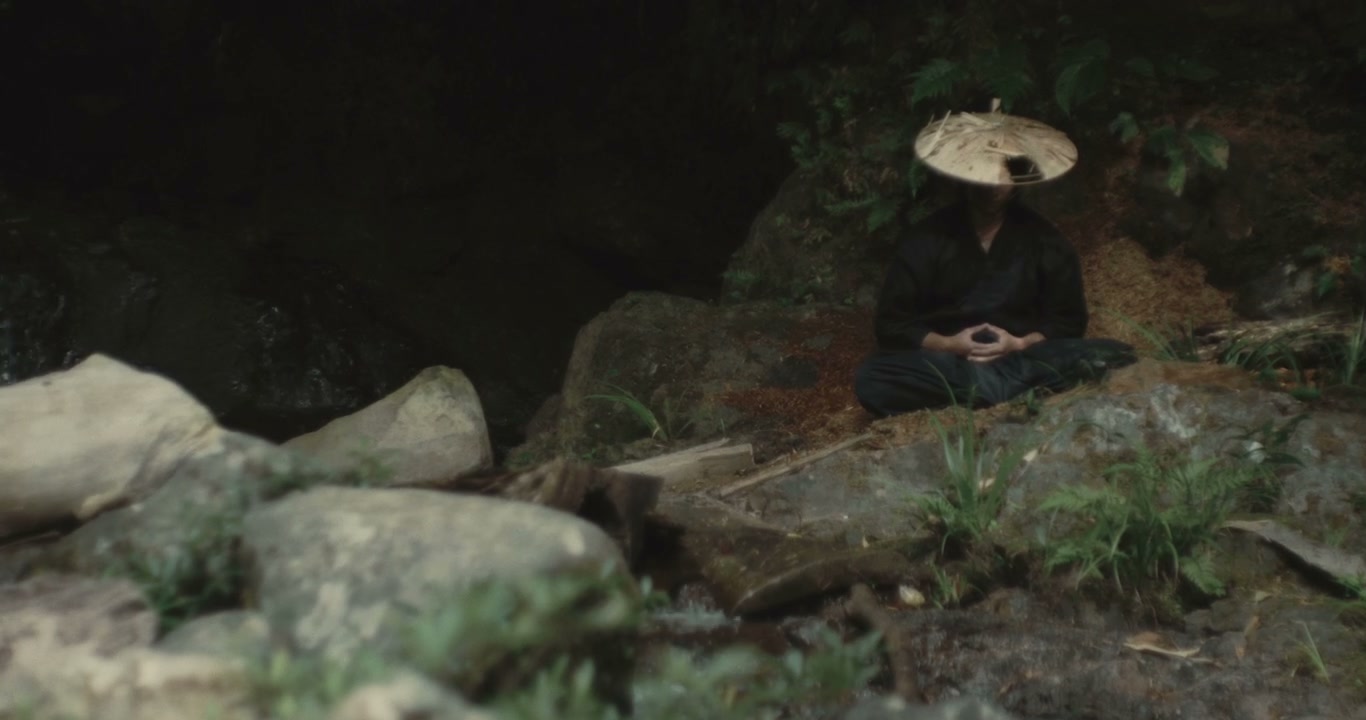 Japanese Person Meditating by Forest Stream