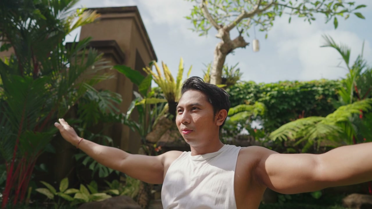 Man Stretching in Tropical Garden