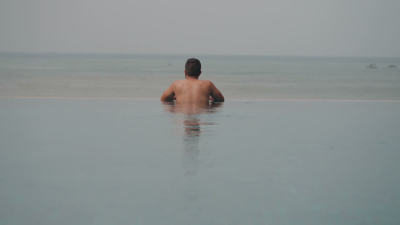 Man Diving into Infinity Pool with Selfie Stick • Stock Video on Uppbeat