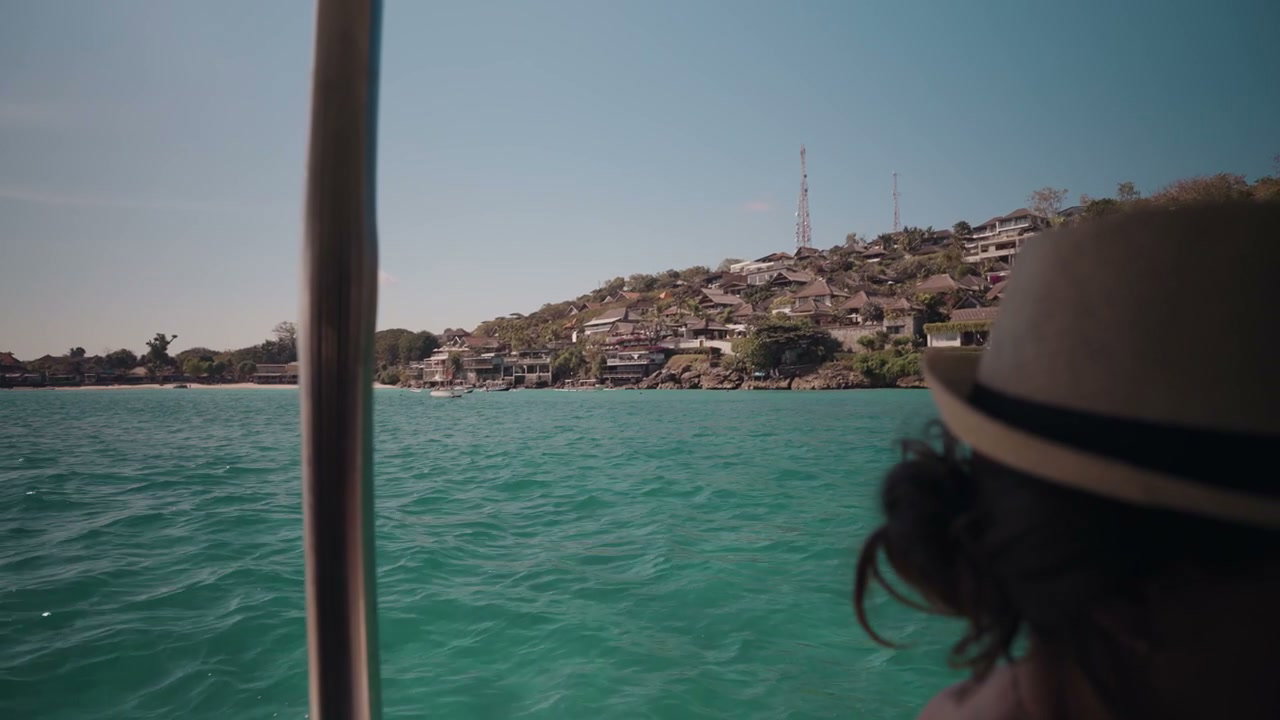 Person on Boat Looking at Tropical Island Coast
