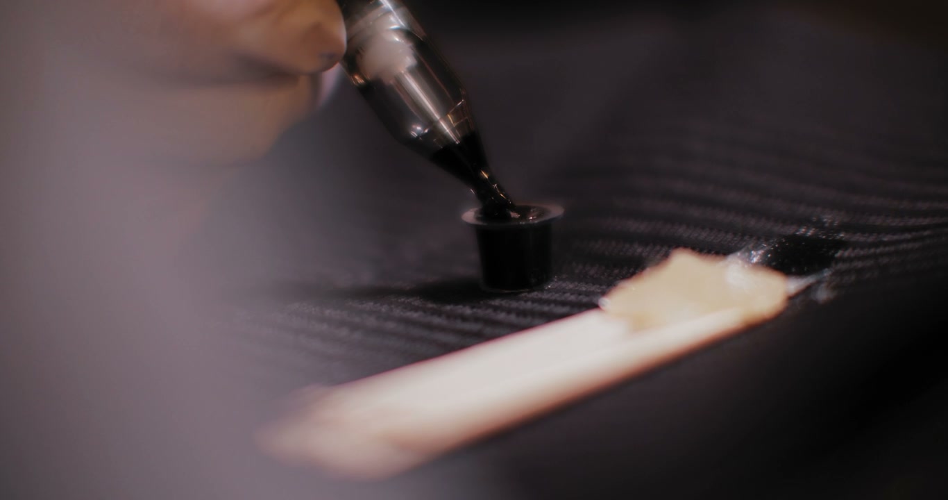 Tattoo Gun Dipping Into Ink
