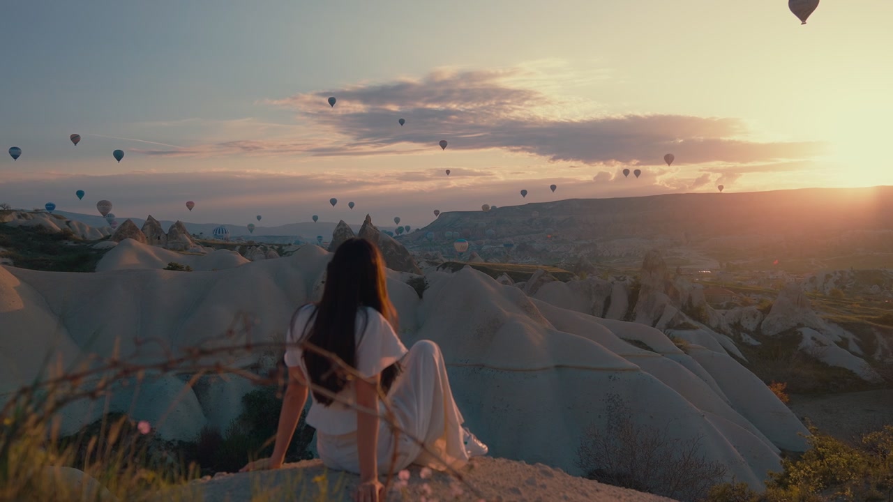 Woman Overlooking Cappadocia Hot Air Balloons