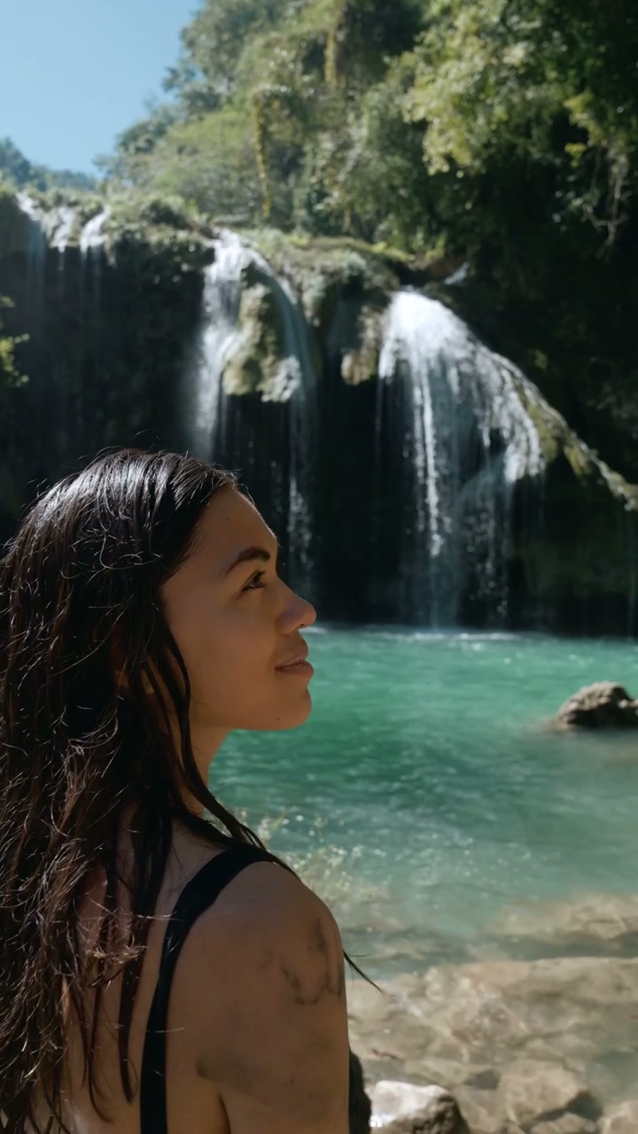 Woman Looking at Tropical Waterfalls