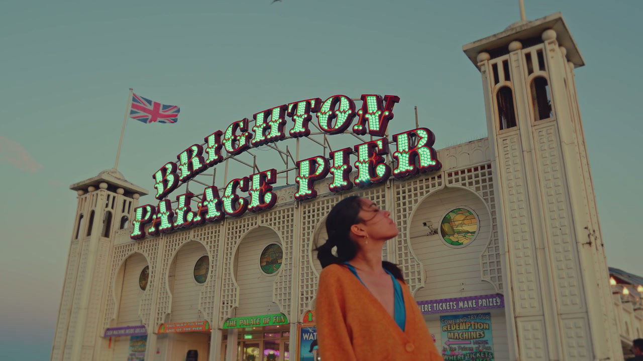 Person Looking Up at Brighton Palace Pier