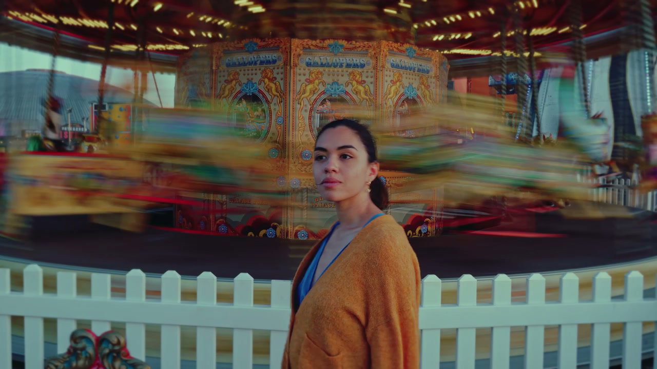Young Woman by Spinning Carousel on Brighton Pier