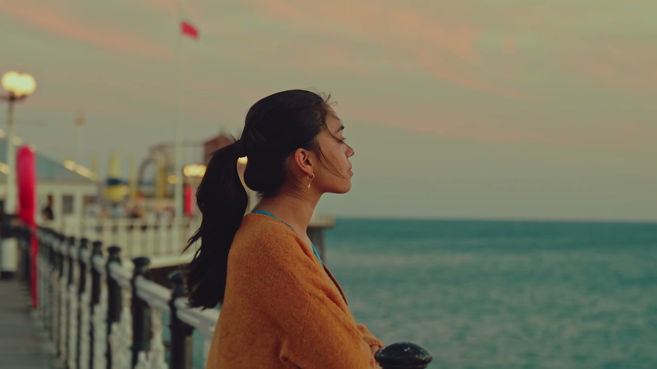 Young Woman on Brighton Pier During Sunset
