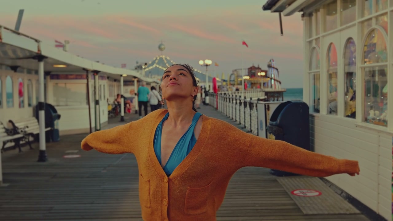 Happy Woman Spinning on Brighton Pier