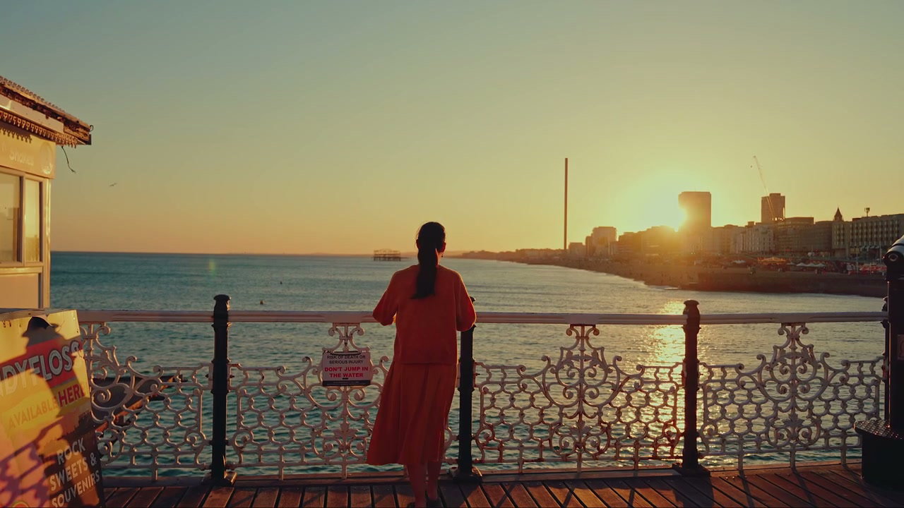 Woman Looking at Sunset from Brighton Pier