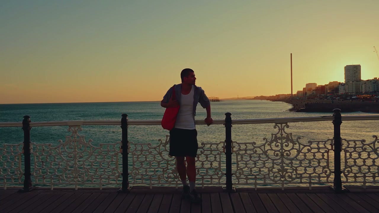 Man on Brighton Pier at Sunset