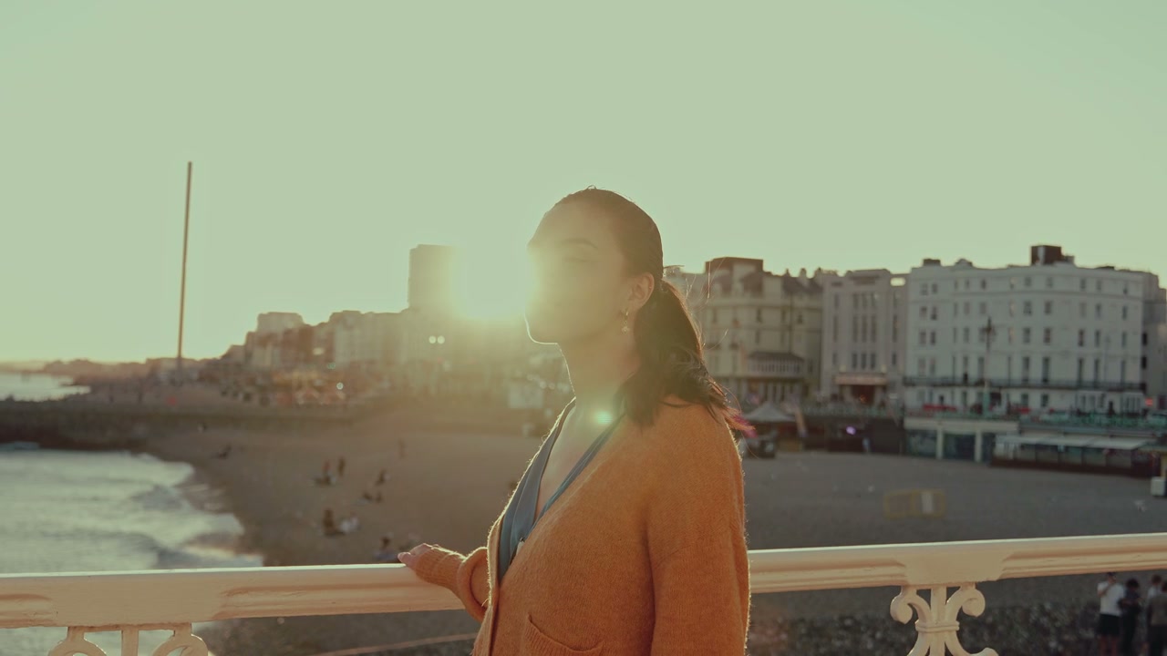 Woman Looking Out at Sunset from Brighton Pier