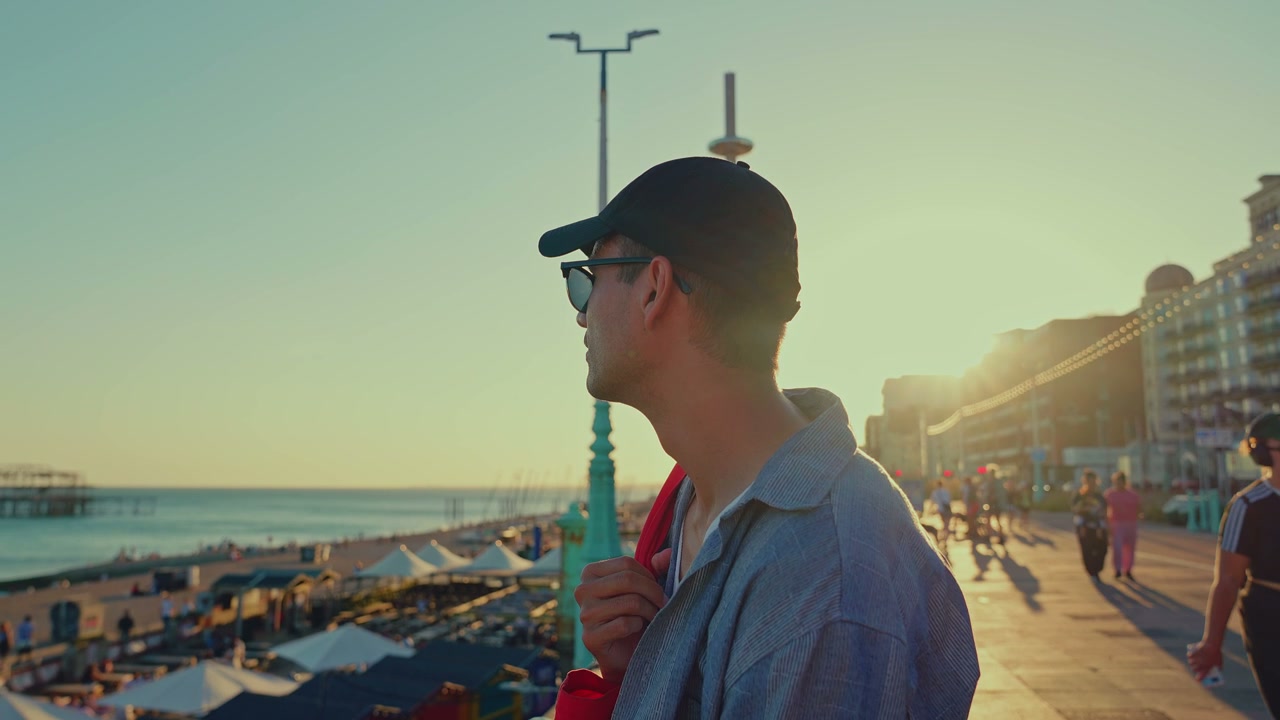 Man Looking Out at Brighton Pier at Sunset