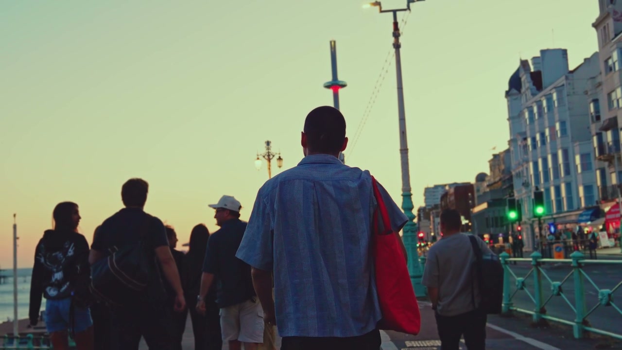 People Walking on Brighton Promenade at Dusk