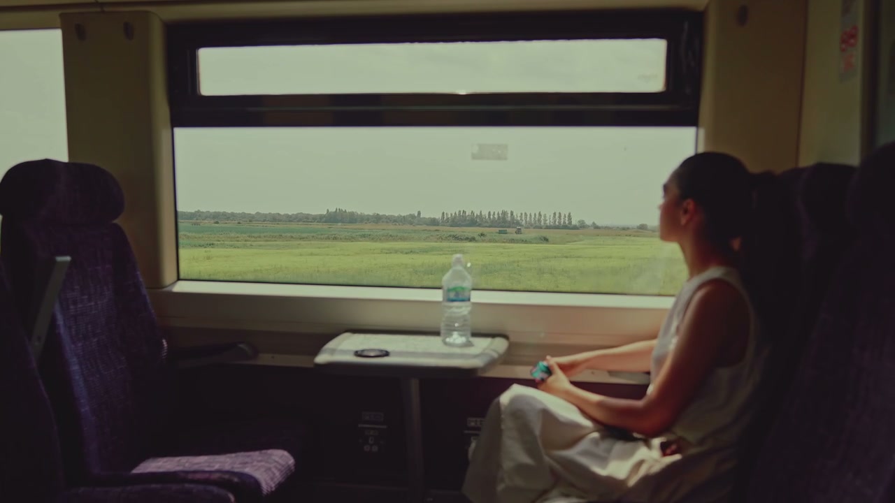 Woman Looking Out Train Window