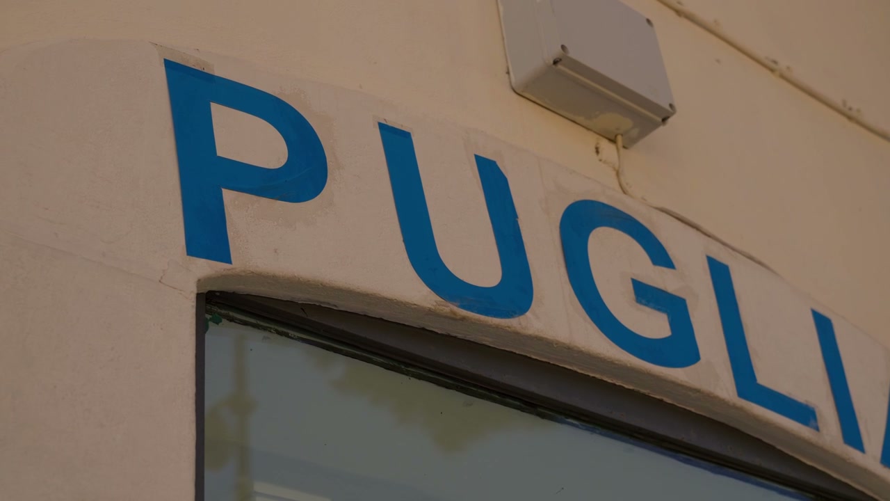 Blue Puglia Sign Over Storefront Window