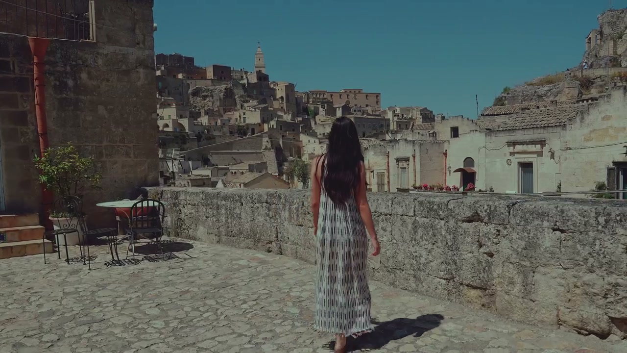 Woman Walks Through Matera Old Town