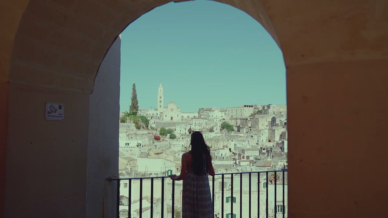 Woman Admiring Matera Cityscape in Italy