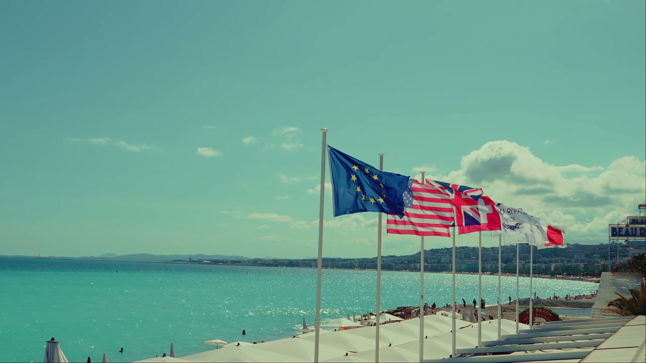 International Flags Waving Over Nice Beach