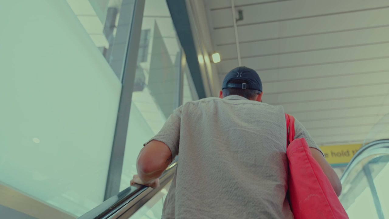 Man on Escalator in London Train Station